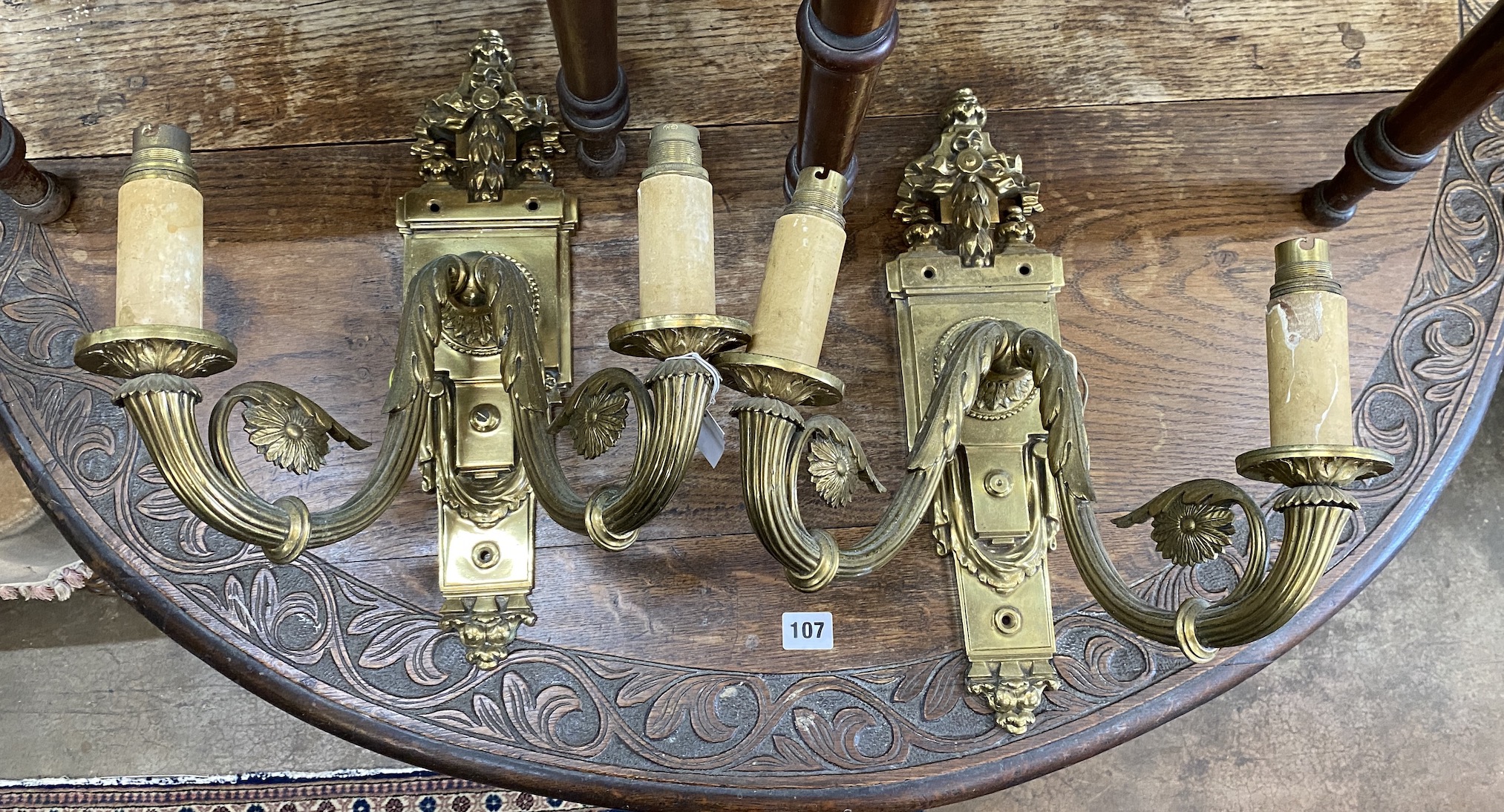 A pair of brass twin branch ormolu wall lights, height 42cm